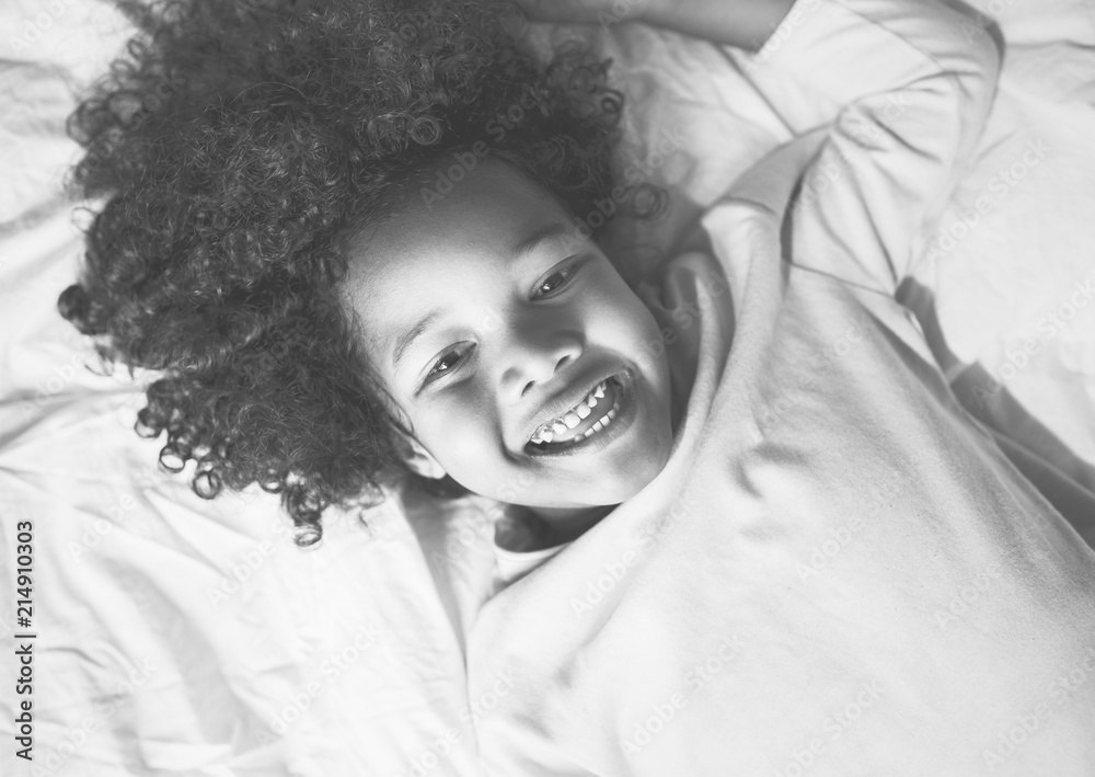 African child enjoying smiling on the bed