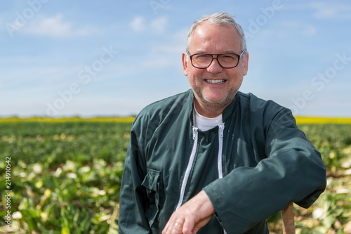 Portrait of a senior attractive farmer working in a field - Nature concept