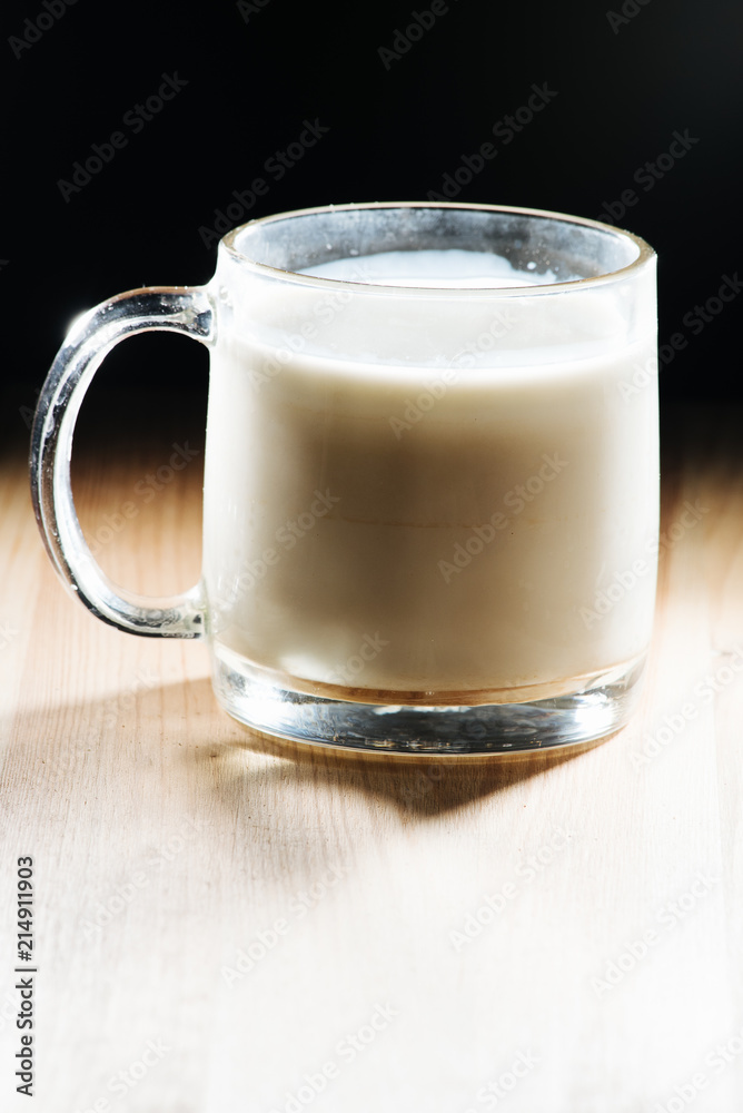 Glass of fresh milk is wooden table on kitchen desk background Glass of fresh milk is wooden table on kitchen desk background