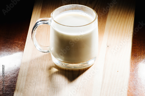Glass of fresh milk is wooden table on kitchen desk background