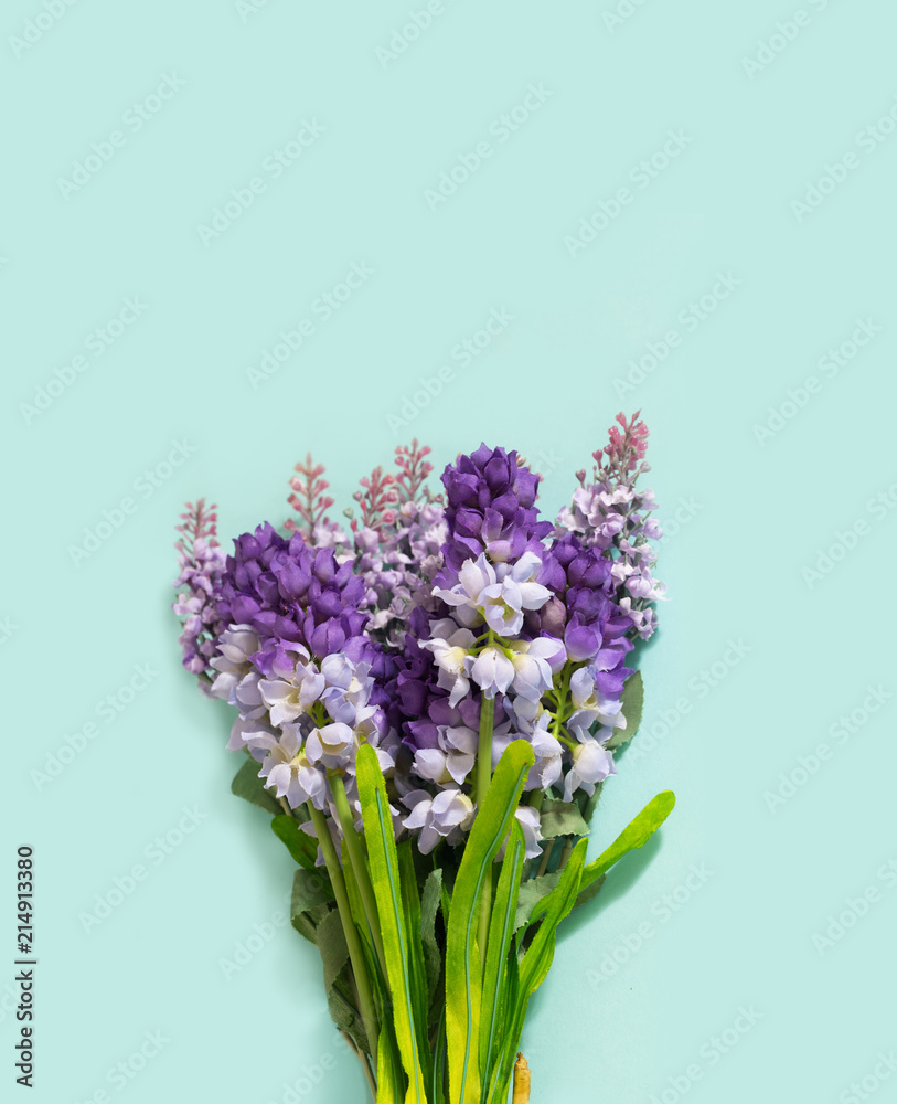 Fototapeta premium Wedding Hand Flower Bouquet Lie on Turquoise Paper Background. Concept of Love and Romantic Expression or Say it with flowers