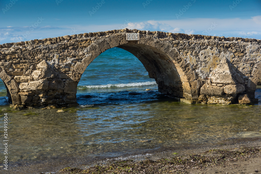 Seascape with medieval bridge in the water at Argassi beach, Zakynthos island, Greece