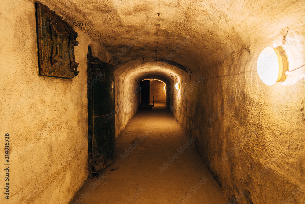 Fototapeta premium Dark corridor of old underground Soviet military bunker under fortification., Sevastopol, Crimea