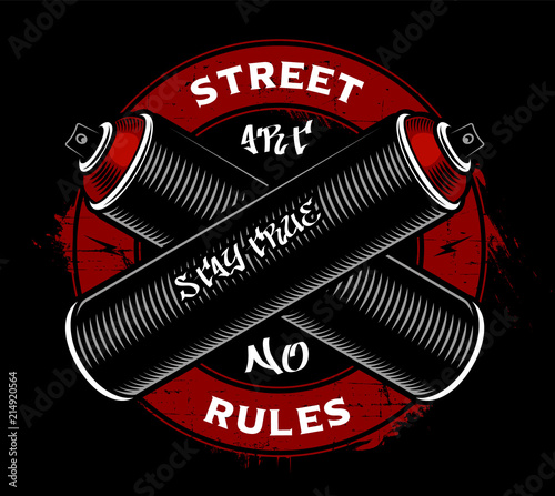 Graffiti logo design. Crossed spray cans on dark background.