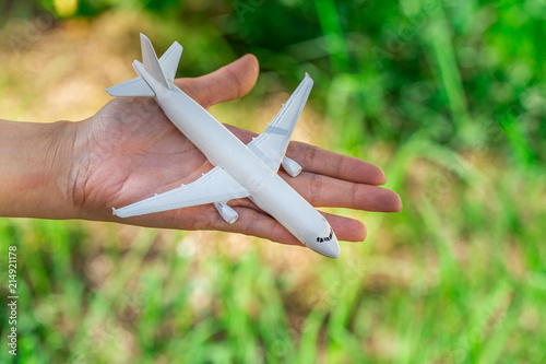 Airplane model in hand on sunny sky. Concepts of travel, transportation © freedom_naruk