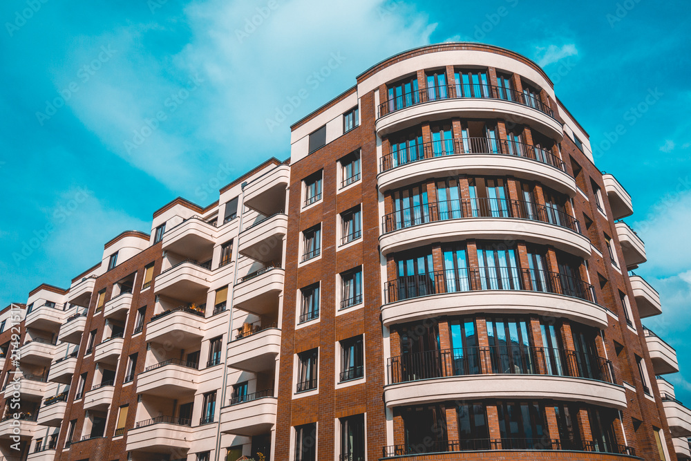 brown colored brick apartment complex with curved balcony brown colored brick apartment complex with curved balcony