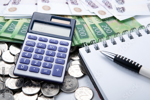 business still-life from a calculator and a bundle of russian banknotes photo