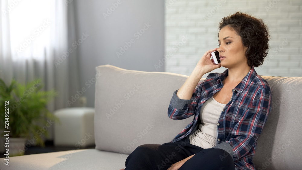 Beautiful woman talking on phone, having serious conversation, looking for job Beautiful woman talking on phone, having serious conversation, looking for job