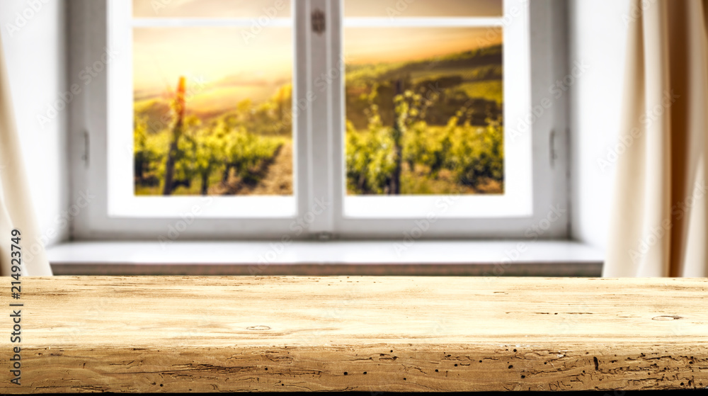 Fototapeta premium Retro old wooden table with free space for your decoration and rural window background. 