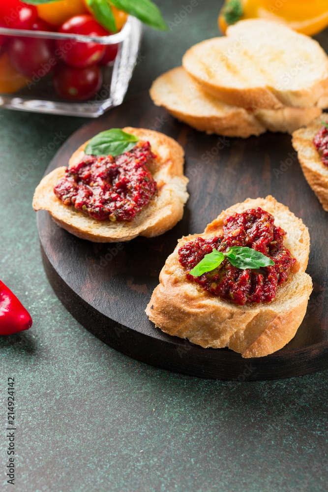 Bruschetta with tomato sauce and basil. Fresh baguette, tomatoes on wooden serving board. Bruschetta with tomato sauce and basil. Fresh baguette, tomatoes on wooden serving board.