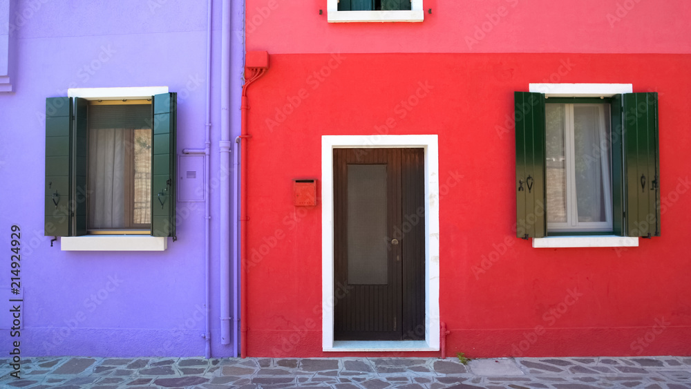 Amazing colorful buildings on Burano island, purple and red houses in Venice
