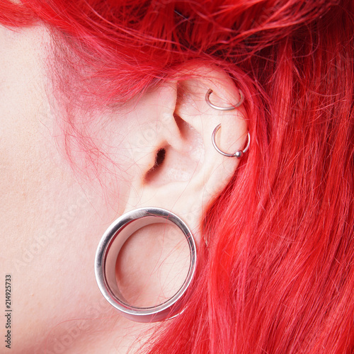 Photo stretched ear lobe piercing with flesh tunnel