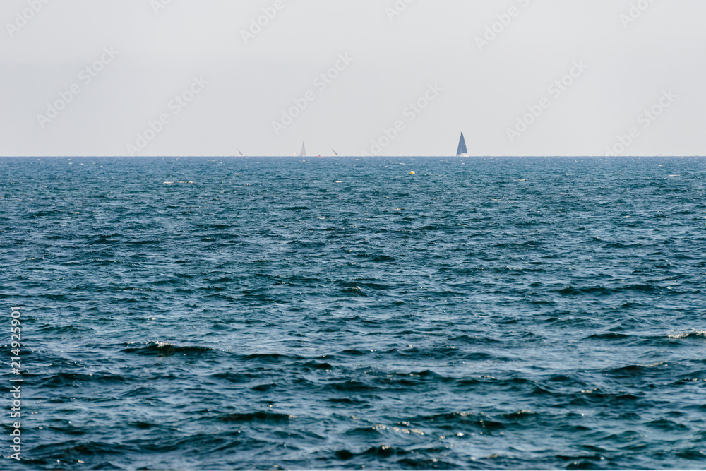 seascape with sailing yacht on the horizon