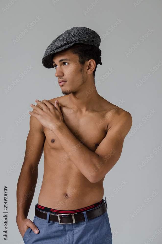 Handsome black man naked with jeans and cap-eight isolated on grey