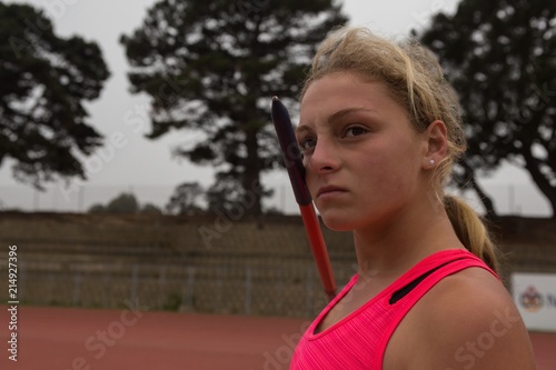 Female athlete practicing javelin throw photo