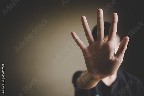 Stop, Child standing with outstretched hand showing stop, Violence concept.