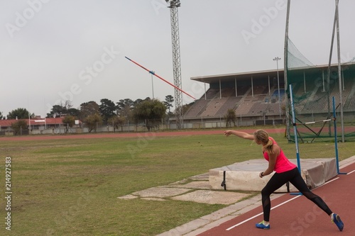 Female athlete practicing javelin throw