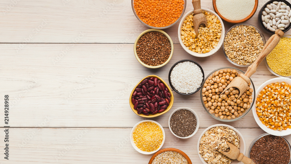 Cereals and legumes assortment on wooden table Cereals and legumes assortment on wooden table