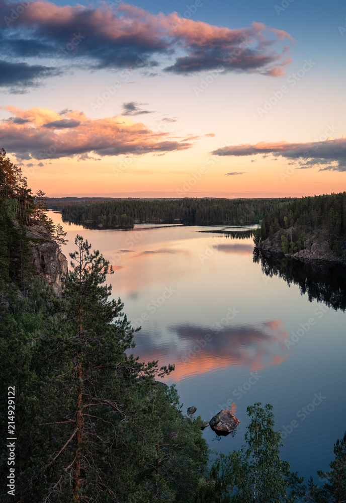 Scenic high angle view with sunrise and peaceful lake at summer evening in Finland