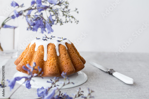 Vanilla cake with sugar icing on a gray background Close up