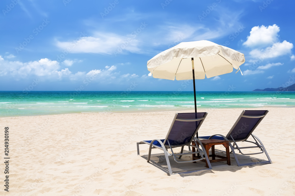 Beach chairs with umbrella and beautiful sand beach