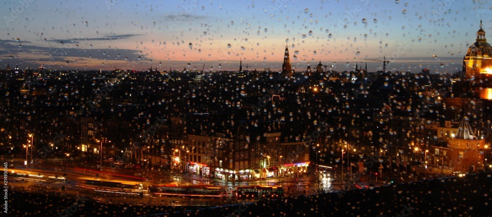 Evening Amsterdam in the rain through the auto window