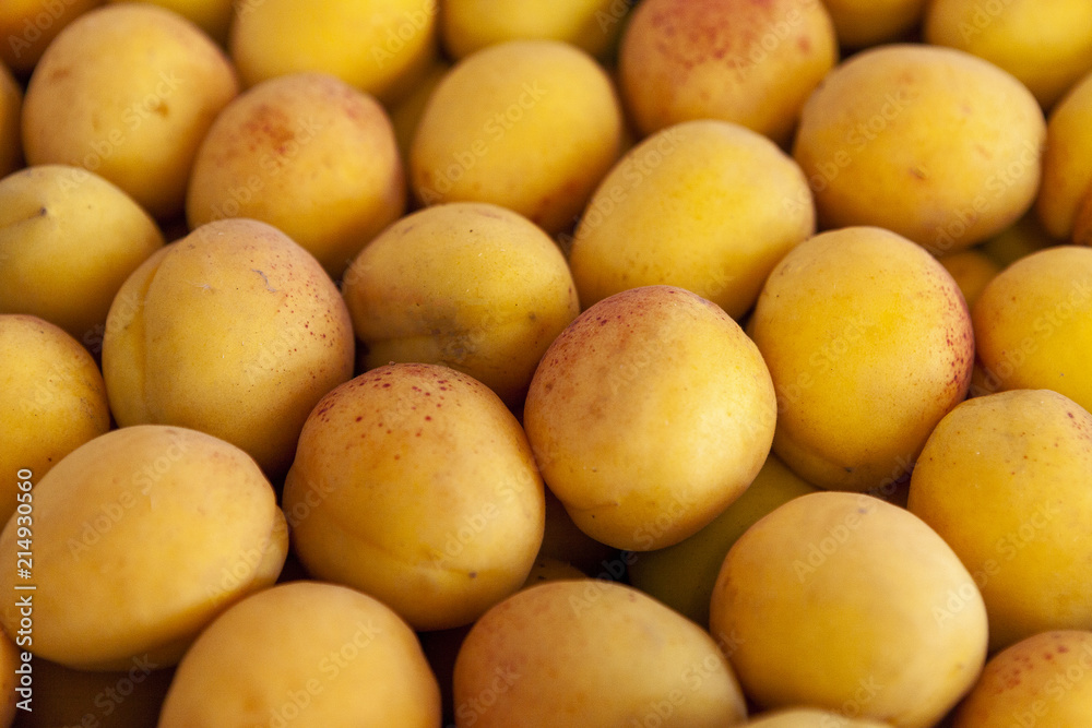 Fresh apricot fruits are laid out in even rows in the shop window. Fresh apricot fruits are laid out in even rows in the shop window.