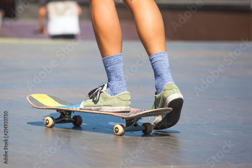 young guy skating in sunny weather