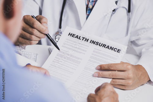 doctor showing a health insurance policy to a man