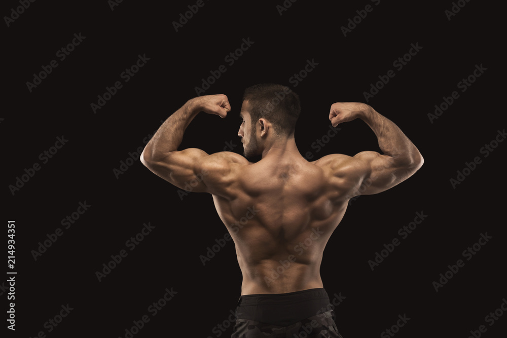 Unrecognizable man shows strong back muscles closeup Unrecognizable man shows strong back muscles closeup