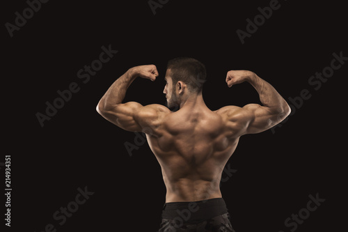 Unrecognizable man shows strong back muscles closeup © Prostock-studio