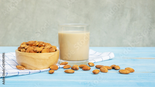 Almond milk on a blue wooden table.