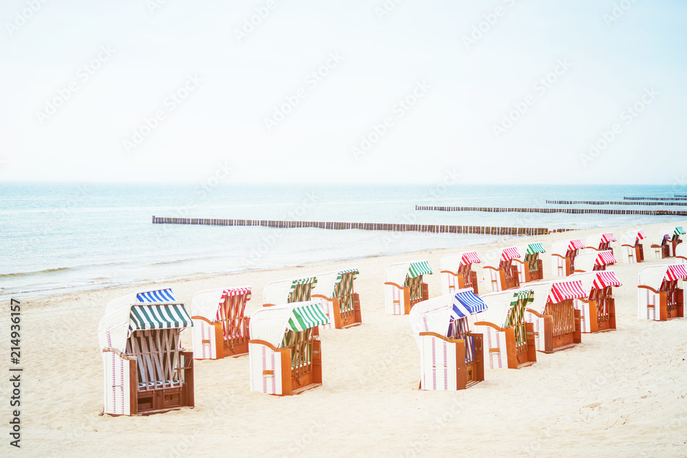 beach with beach chairs and breakwaters