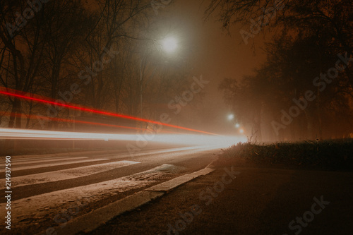 long exposure of traffic in a small city on a foggy night moody grunge overlay