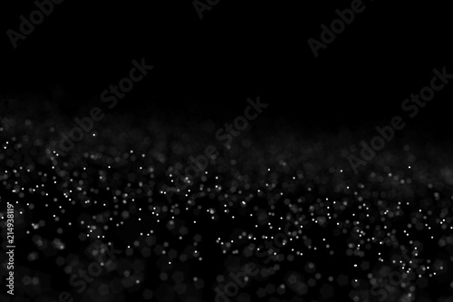 Falling dust cloud design . Particles cloud background, wallpaper with copy space. Rain, snow fall concept . Freeze motion of white powder coming down, isolated on black, dark background.