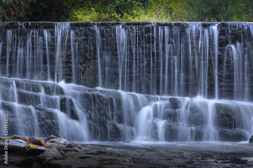 The weir on the Lower Clydach River just a hundred yards or so from the High Street main road  Swansea  South Wales  UK  