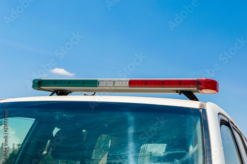 Roof light on the Marocan police car. Green, white and red emergency vehicle lighting.