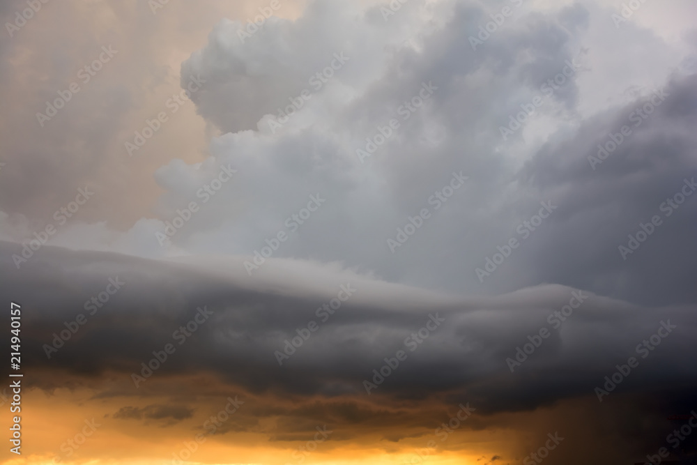 Obraz premium Dramatic fiery stormy sky in a mixture of yellow, orange, gray and black colors
