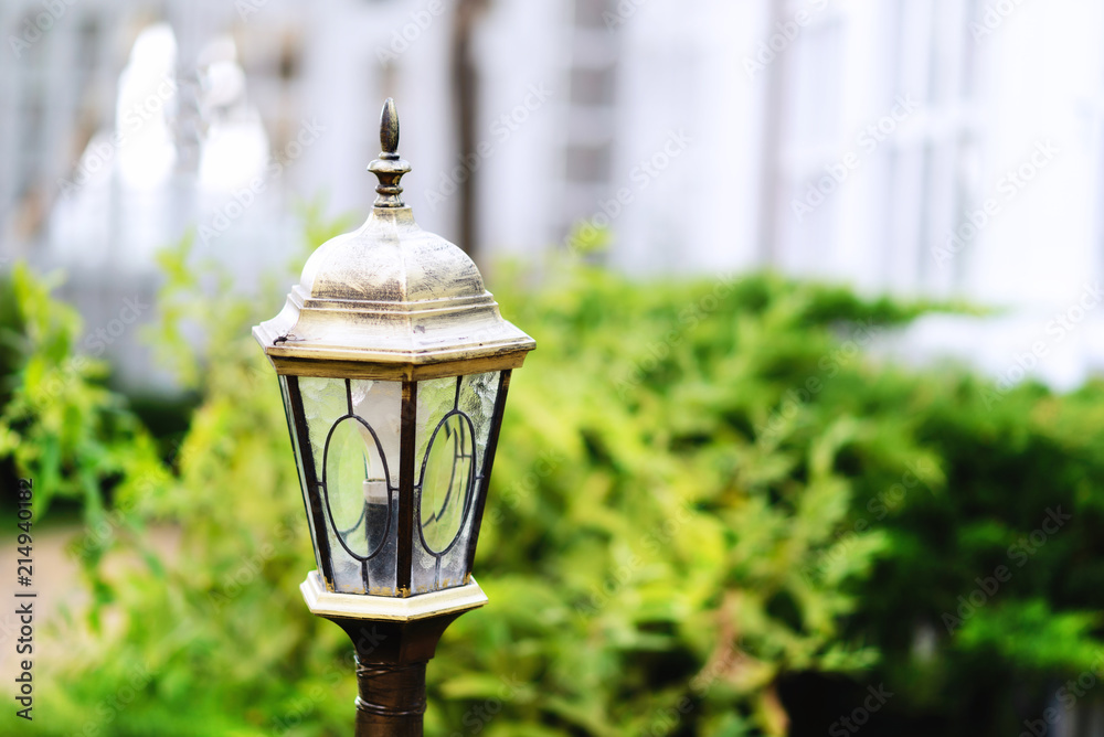 Shabby garden light in a summer day. Green leaves in the background