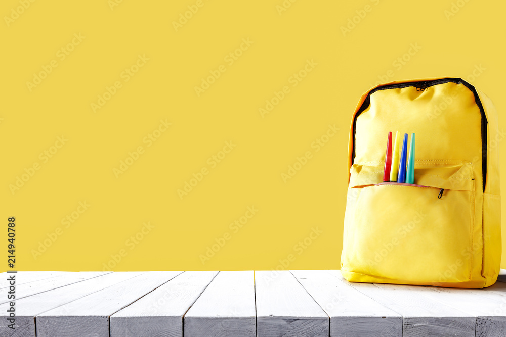 Yellow school backpack and free space for your decoration.  - obrazy, fototapety, plakaty 