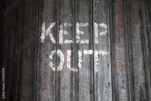 Keep Out. Keep out sign on a weathered wooden background. photo