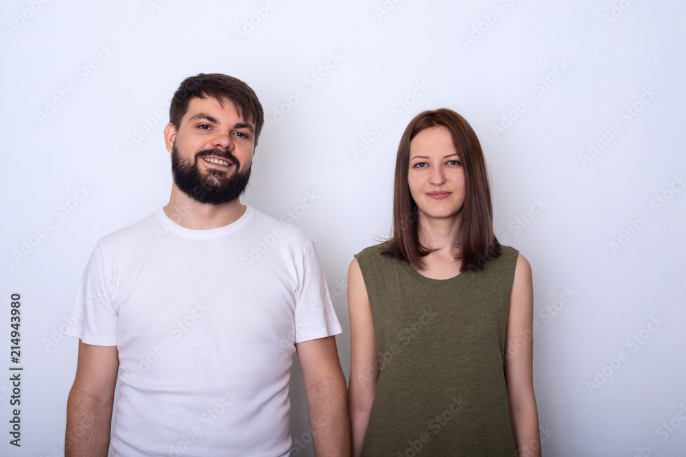 Young couple in casual clothes looks at camera Young couple in casual clothes looks at camera