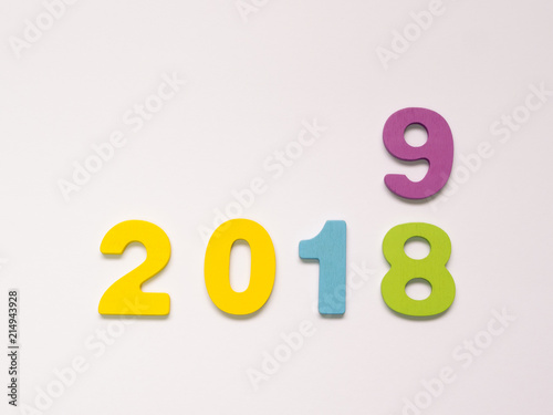 Colorful wooden numbers on white background. New year concept. Change the year 2018 to 2019.