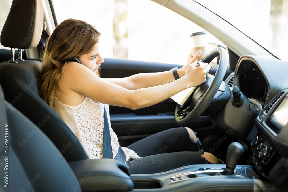Woman multitasking while driving Woman multitasking while driving