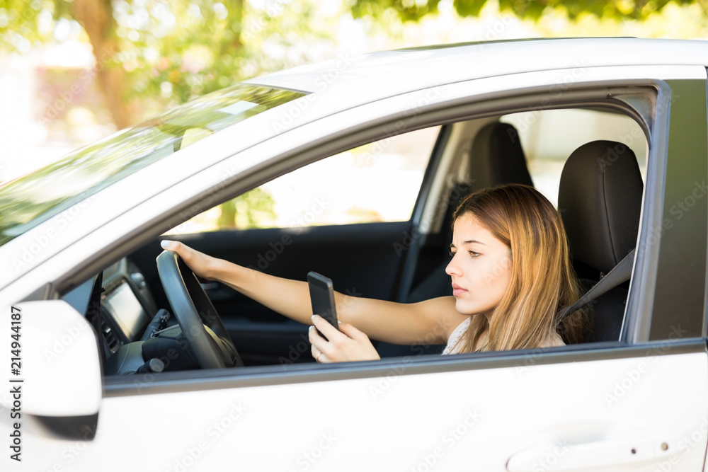 Woman using phone while driving