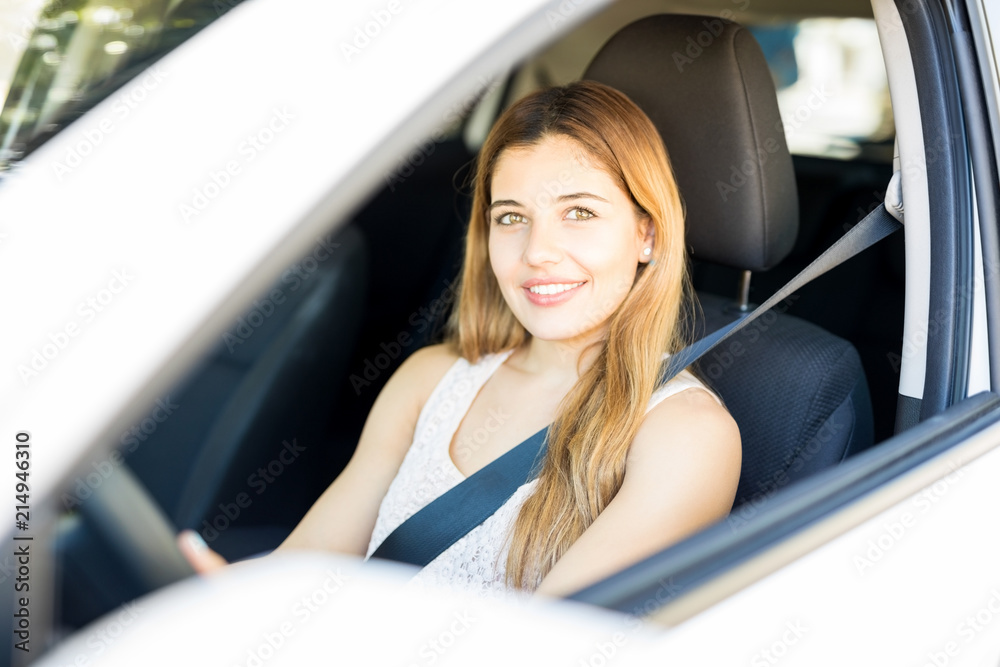 Attractive woman on driving seat of car