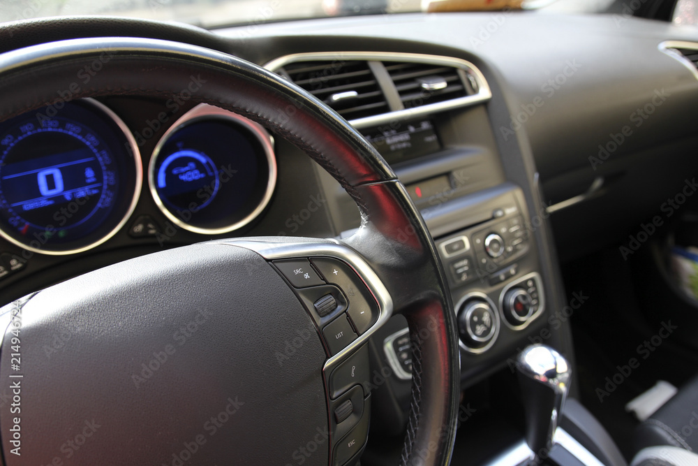 Steering wheel on the black car dashboard Steering wheel on the black car dashboard
