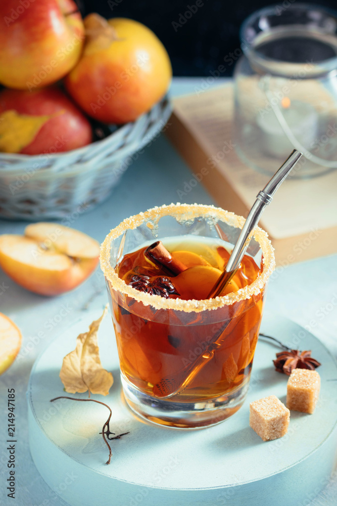Apple cider drink, hot cocktail with cinnamon sticks and apple slices. Tea with spices. Autumn cozy mood. Close up view Apple cider drink, hot cocktail with cinnamon sticks and apple slices. Tea with spices. Autumn cozy mood. Close up view