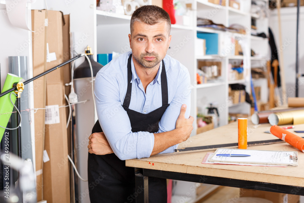 man designer and print operator with paper print at the print manufacturing man designer and print operator with paper print at the print manufacturing