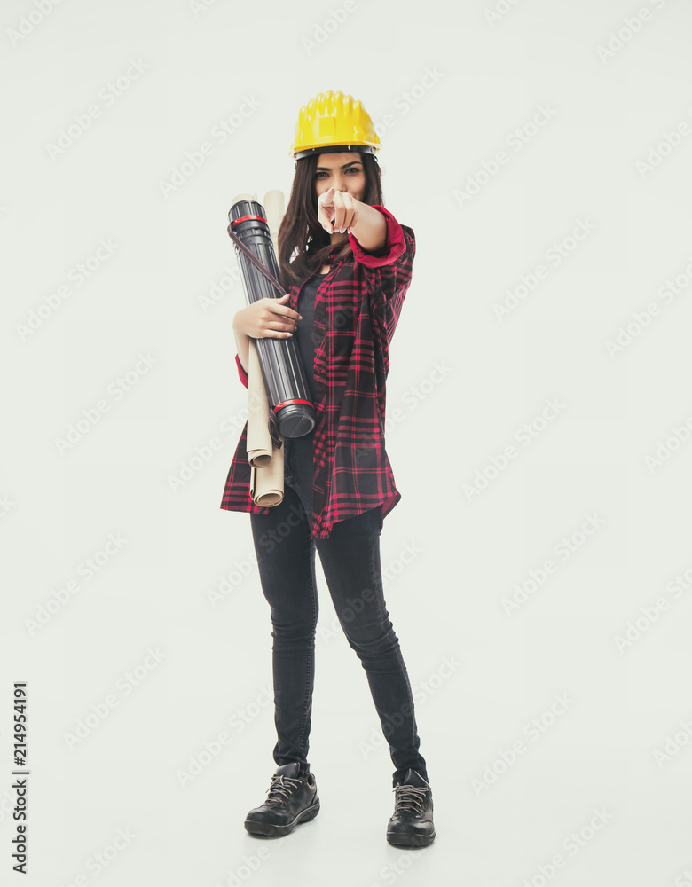 The classic old film design background of young woman engineer with yellow safety helmet and hold blueprint in right hand,point finger forward,vintage tone, The classic old film design background of young woman engineer with yellow safety helmet and hold blueprint in right hand,point finger forward,vintage tone,